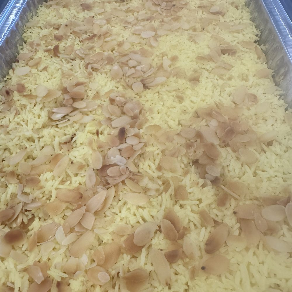 Basmati rice with slivered almonds in a catering tray
