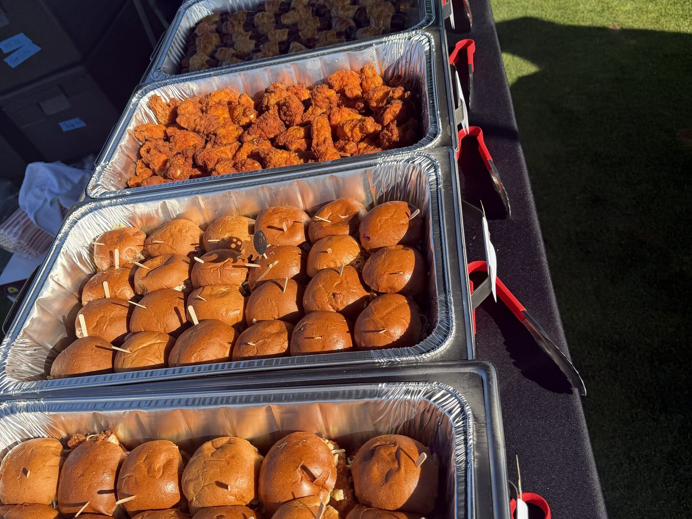 Catering trays of sliders and chicken delivered and set up on site at a Bay Area venue
