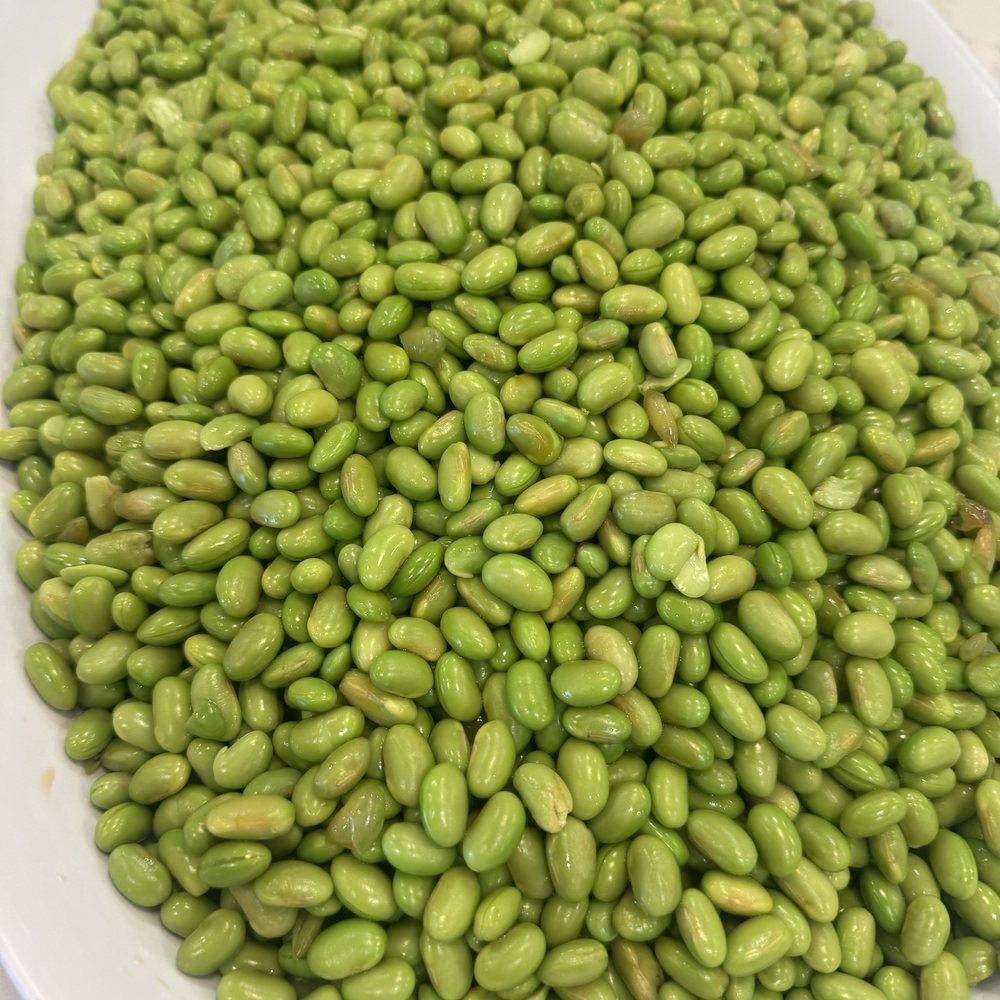 Edamame served on a white platter as part of an Asian corporate catering package