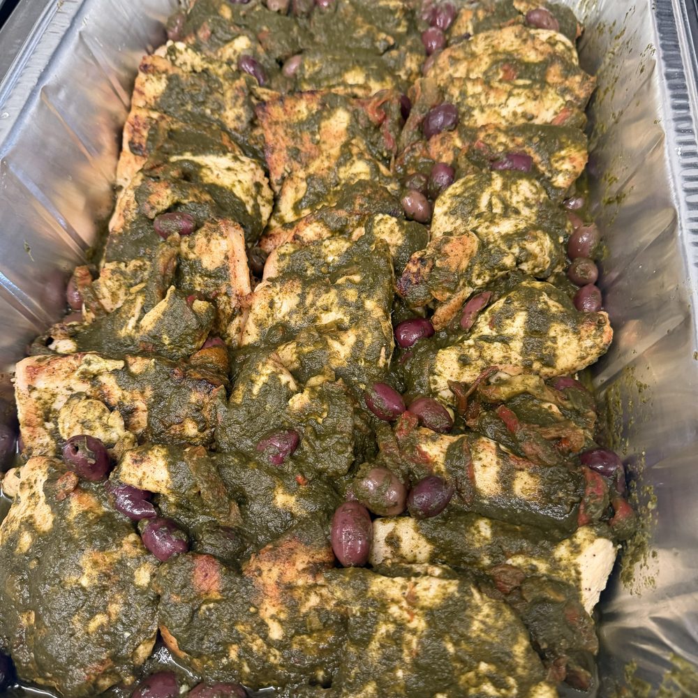 Herb-roasted chicken with olives in a catering tray