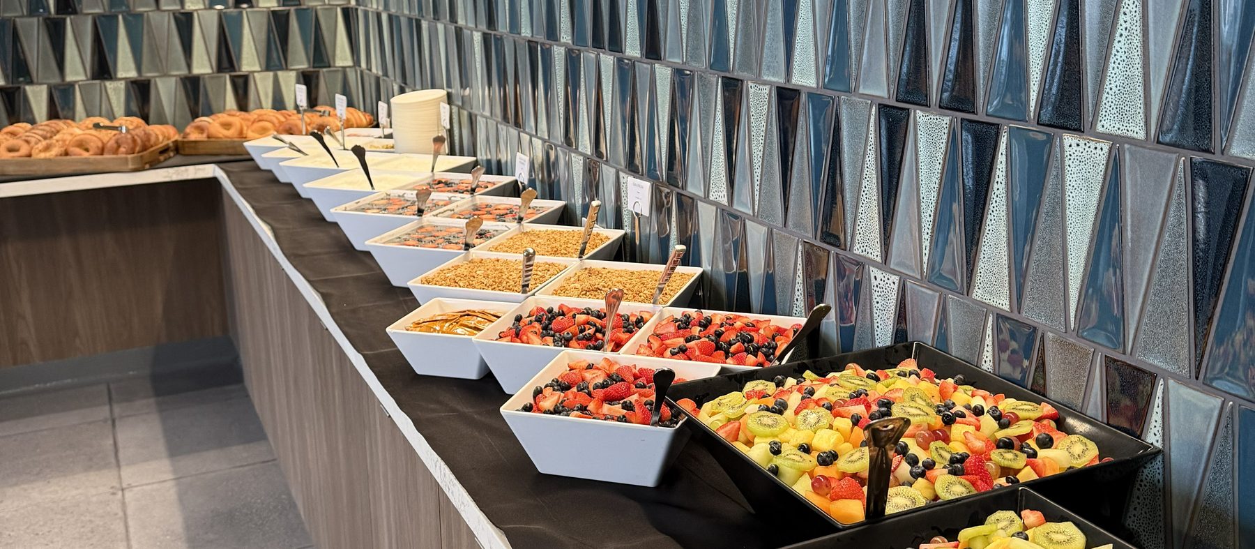 Corporate catering set out along a buffet wall at a San Francisco office before guests arrive