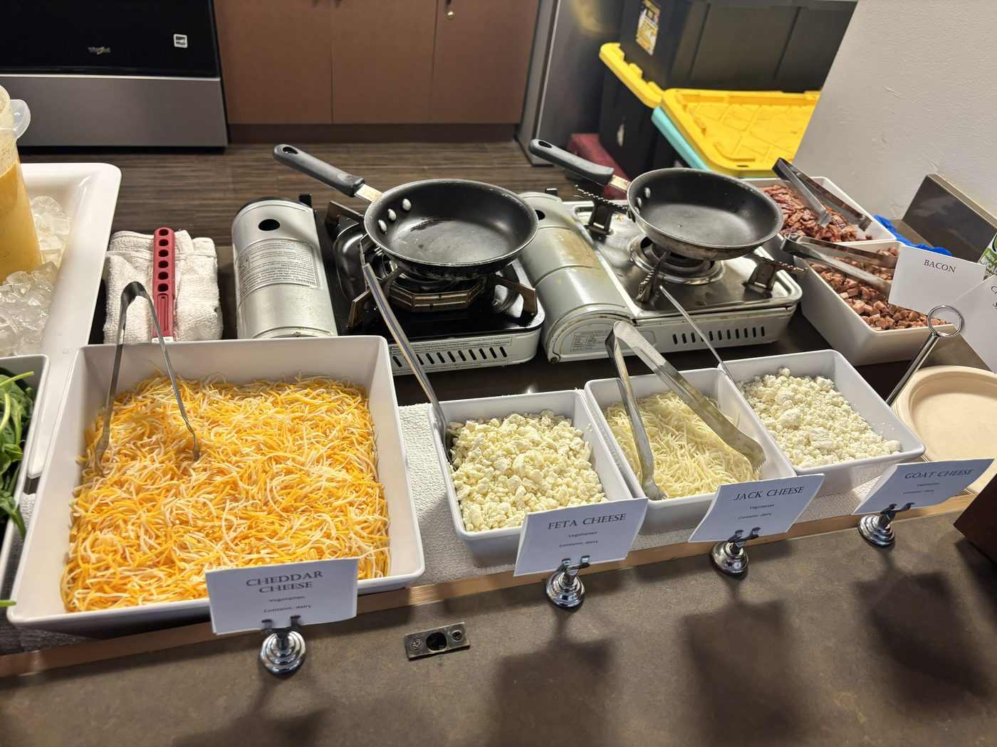 Build-your-own station with printed cards naming cheddar, feta, jack and goat cheese