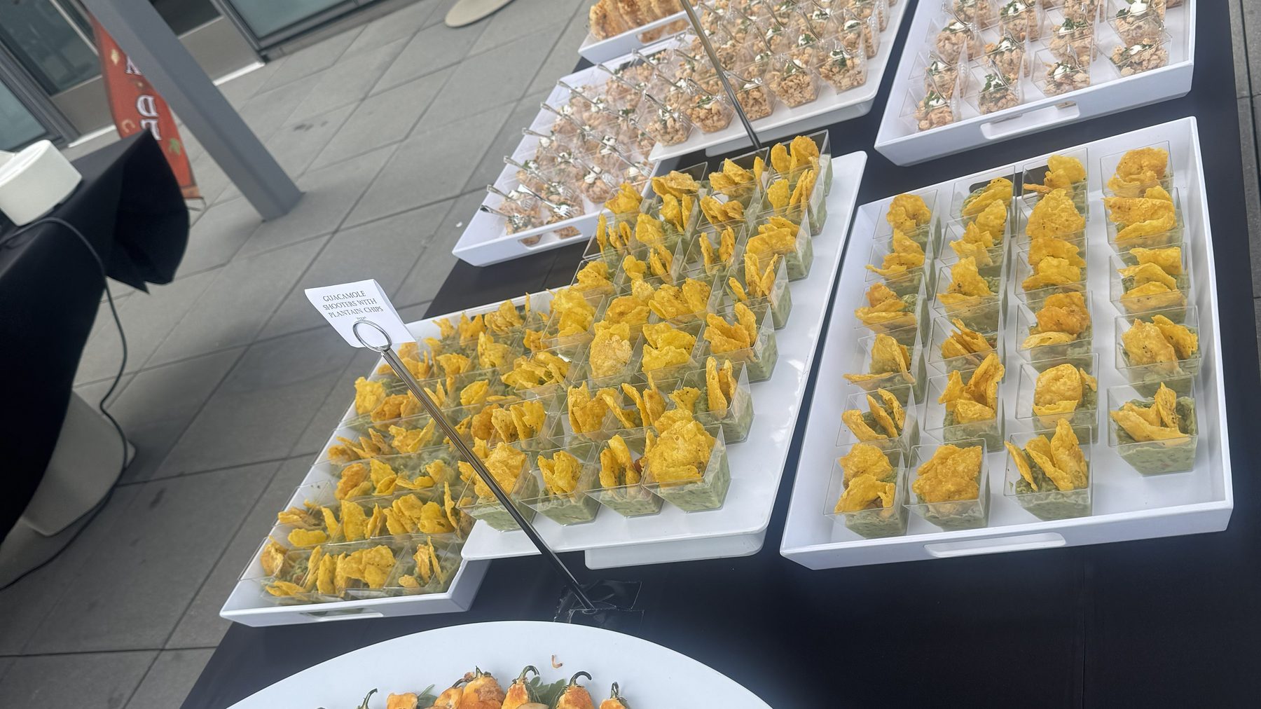 A large catering order of individual servings laid out across a long table in a Bay Area office
