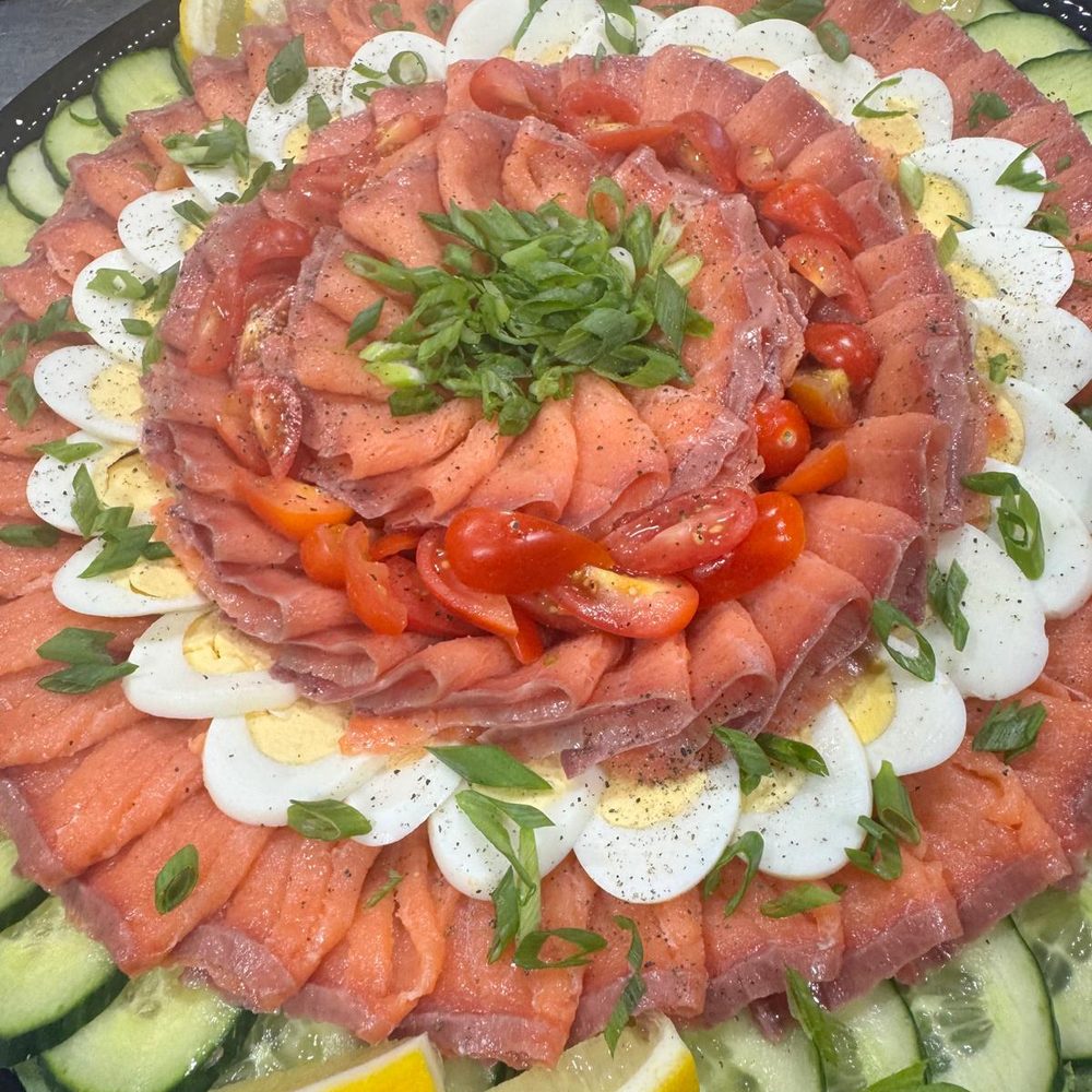 Smoked salmon platter with egg, cucumber and tomato for corporate catering